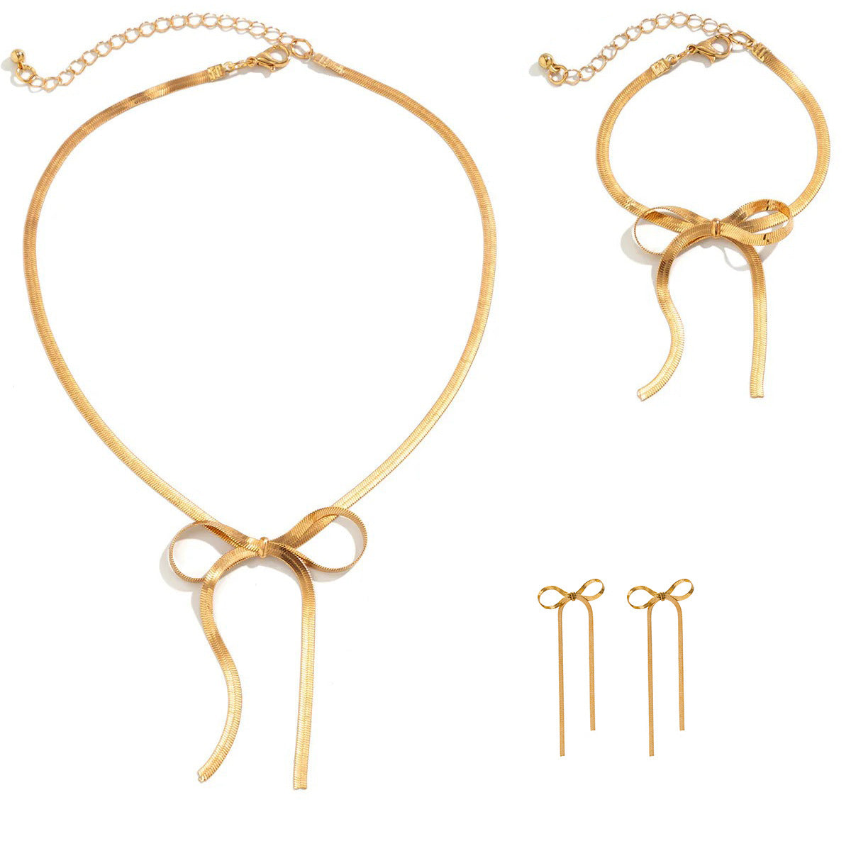 Trendiges Schlangenketten-Set aus Edelstahl in eleganter Box, vergoldet, bestehend aus Halskette, Armband und Ohrringen. Damen-Schmuck im Balletcore-Stil mit Schleifen-Ohrringen.